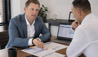 Advisor pointing at figures on a document
